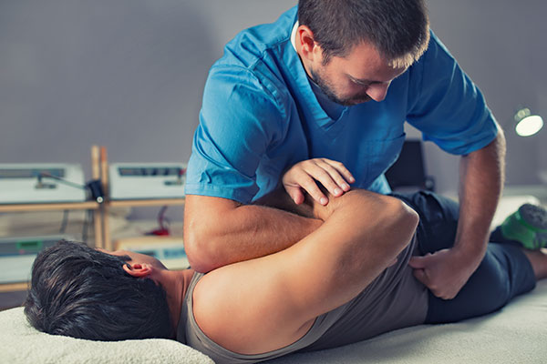 Patient lying down receiving Chiropractic adjustment