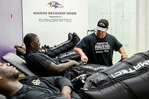 Baltimore Ravens NFL players getting treatment with NormaTec compression therapy